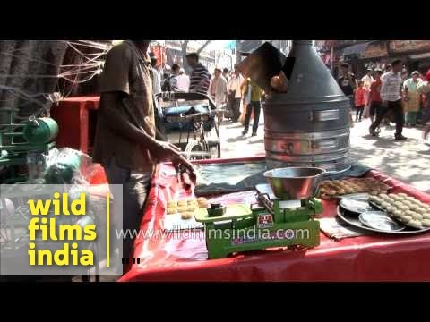 Man baking cookies in typical coal fired oven in Haridwar market